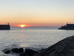 Experience the serene tranquility of a seaside escape with breathtaking views of the ocean and two iconic lighthouses.