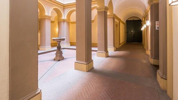 A corridor with arches, columns, and a fountain. - TREVI LUXURY PENTHOUSE with panoramic terrace (Roma)