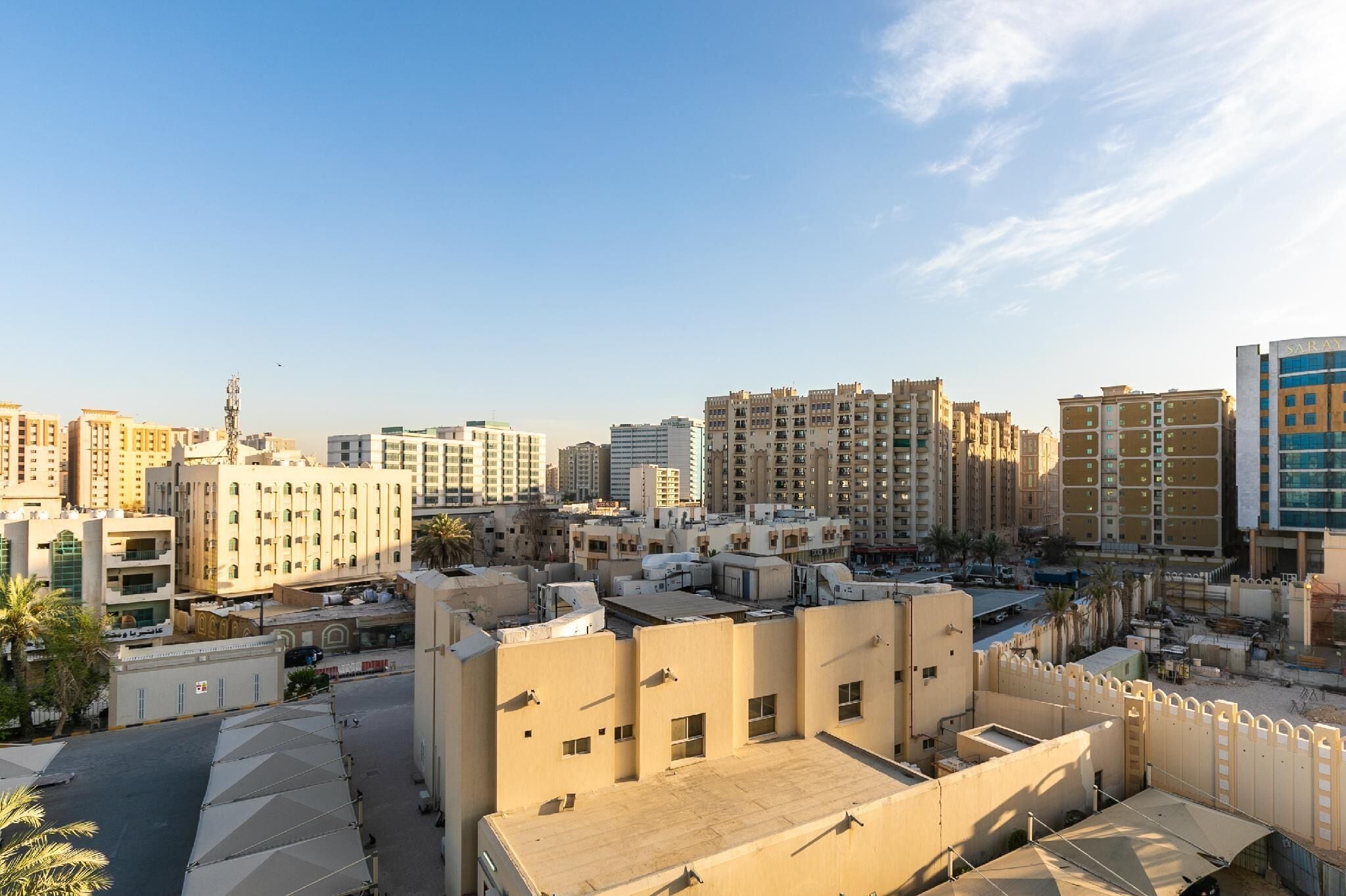 A high-rise residential area with multiple apartment buildings, some with balconies and others with flat rooftops.