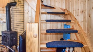 A wooden staircase with blue steps and a black pipe on the left. - Awesome home in Bobolin with kitchen (Bobolin)