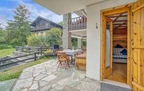Enjoy dining and socializing in this outdoor patio area, complete with a grill and comfortable seating.