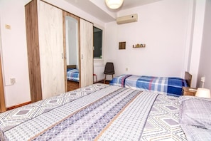 Cozy retreat with a single bed, wardrobe, and bedside table, perfect for a relaxing stay.