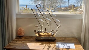A wooden desk with a model ship and a starfish decoration. - Beach House steps to private beaches in sought after location! (Old Saybrook)