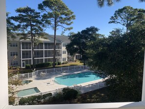 Guests can enjoy a pool and outdoor space with a balcony view.