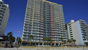 A high-rise hotel with multiple floors, balconies, and a beachside location. - Grande Atlantic 807 - 4 Bedroom Oceanfront Unit (Myrtle Beach)