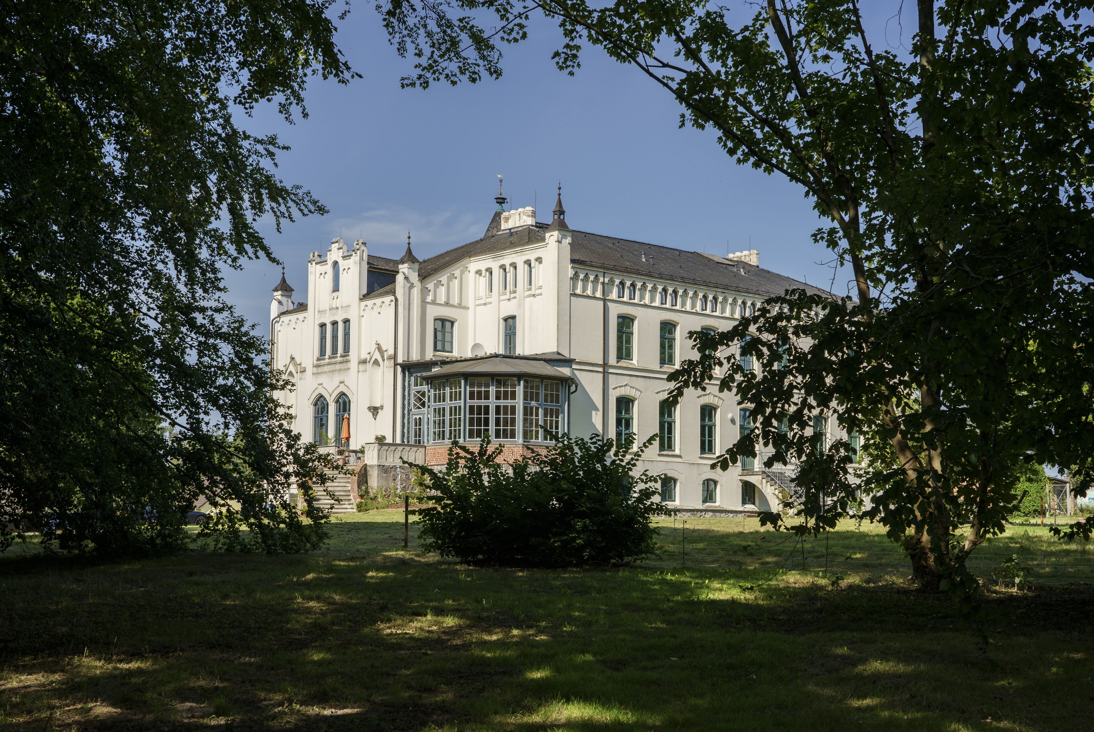 A large, historic building with a symmetrical facade, multiple windows, and a central entrance.