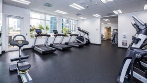 A gym with treadmills, a stationary bike, and a rowing machine. - Amazing 2BR APT @Brickell, Free Parking (Miami)