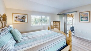 A bedroom with a bed, a dresser, and a window. - 300 Steps to the Emerald Beach (Destin)