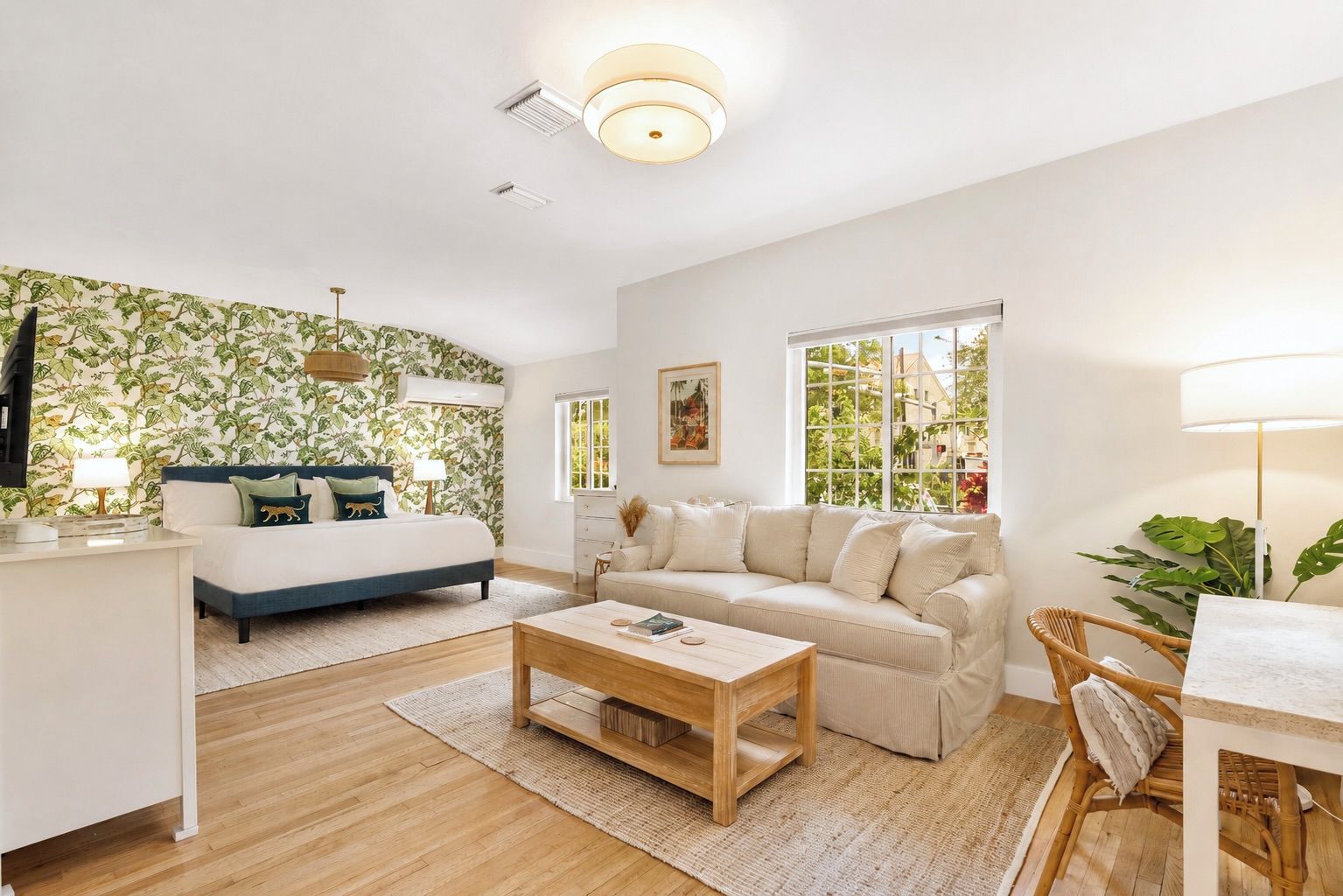 A modern living room with a sofa, a coffee table, and a TV.