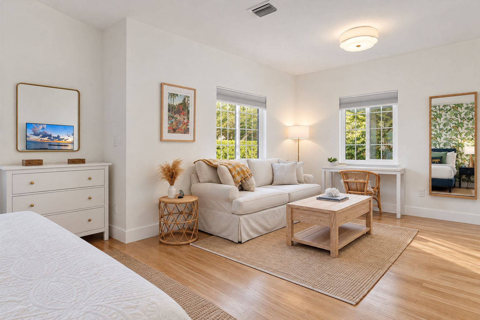 Bright, airy suite with cozy sofa, desk, and peaceful natural light