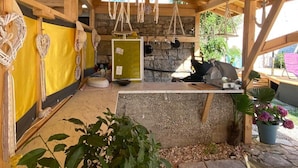 A rustic wooden structure with a stone wall, a yellow wall with decorative items, and a hanging dreamcatcher. - Studio apartment in Funtana with Balcony, Air condition, WIFI, Washing machine (4982-2) (Funtana)