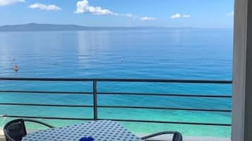 Enjoy the ocean view from this balcony with a table for two.