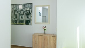 A room with a wooden floor, a small wooden cabinet with a mirror, a framed picture on the wall, and a bright yellow bed. - Apartment in Drašnice with Seaview, Terrace, Air condition, WIFI (4992-3) (Drašnice)