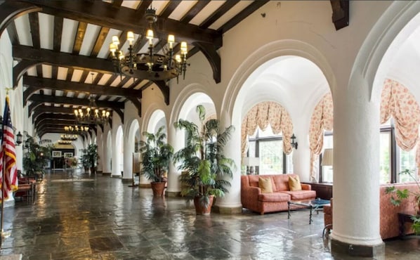 Experience the grandeur of our lobby, featuring high ceilings, arched columns, and comfortable seating areas.