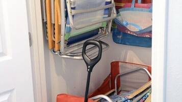 Storage solutions abound in this well-organized room, featuring a metal rack and storage cart.