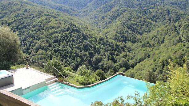 A swimming pool with a view of a forested valley. - Gorgeous apartment in CARCHETO BRUSTICO (CARCHETO BRUSTICO)