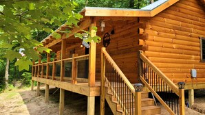 A wooden cabin with a porch, a staircase, and a window. - Secluded East TN Log Cabin (Ten Mile)