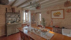 A rustic dining area with a wooden table, chairs, and a buffet setup. - 4Bed3Bath 1736 Farmhouse/Barn Conversion-Hearth (Sainte-Soline)