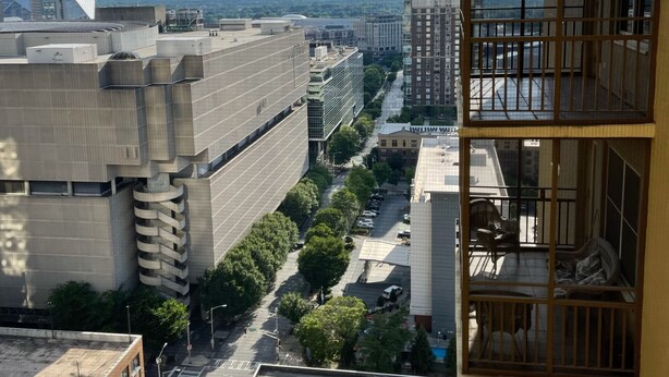 A high-rise building with multiple floors, large windows, and a view of a cityscape. - Cozy place in heart of Atlanta  (Atlanta)