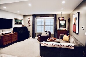 Smart TV, fireplace, books, computer monitors