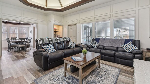 A spacious living room with a high ceiling, a dining area, and large windows. - Family friendly/POOL/Sleeps 16/Luxury (Plano)