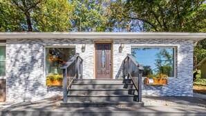 A two-story house with a front porch, a wooden staircase, and a brick exterior. - LOCATION - DUNWOODY; NEW-BEAUTIFUL MODERN HOUSE & Outdoor Seasonal Private Pool (Atlanta)