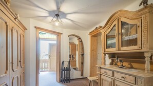 A hallway with wooden cabinets and a large mirror. - Holiday home on a former stables (Brixen im Thale)