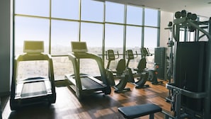 A gym with treadmills, elliptical machines, and weight equipment. - Boulevard hotel (Seeb)