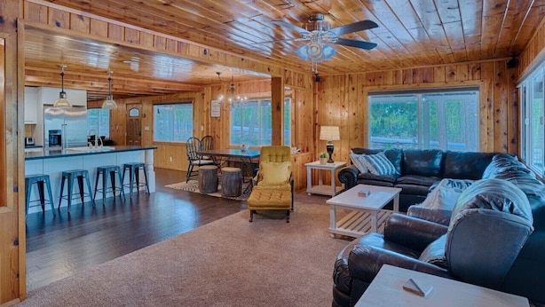 A spacious cabin interior with a kitchen, dining area, and living room. - Super Cute Cabin in the Pines (Lakeside)