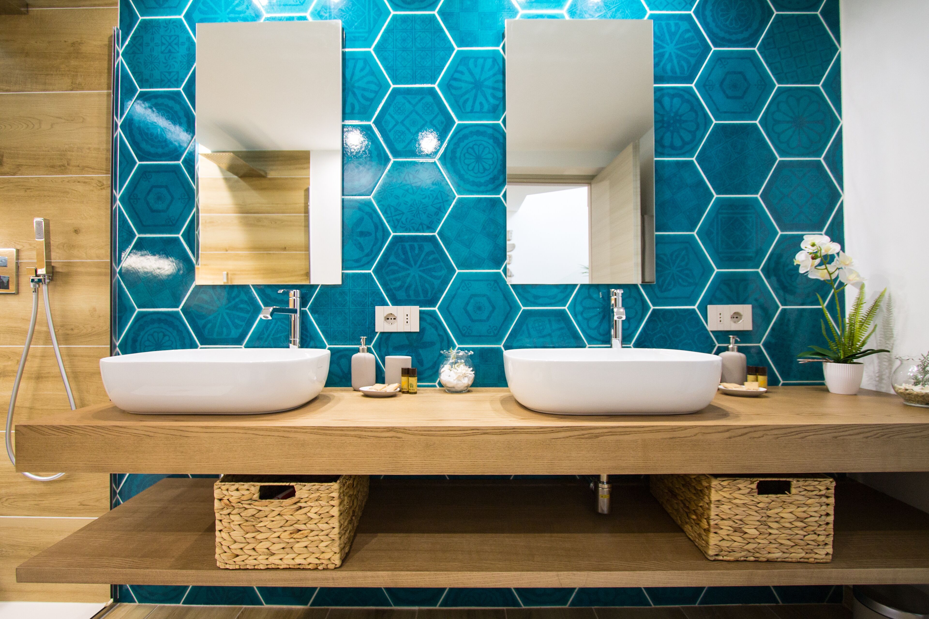 A bathroom with two sinks, a mirror, and a wooden vanity.