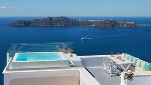 A rooftop terrace with a pool, dining area, and a view of the sea and islands. - 2 Bed Villa - Sleeps 4 - Pool - Private Chef (Santorini)