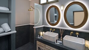 A modern bathroom with two sinks, a large mirror, and a towel rack. - 2 Bed Villa - Sleeps 4 - Pool - Private Chef (Santorini)