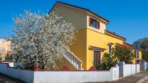 A yellow building with a red roof, white walls, and a staircase leading to the entrance. - 1 bedroom beautiful apartment in Pula (Pula)