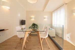 Enjoy meals in this stylish dining area with a glass-top table and comfortable seating.