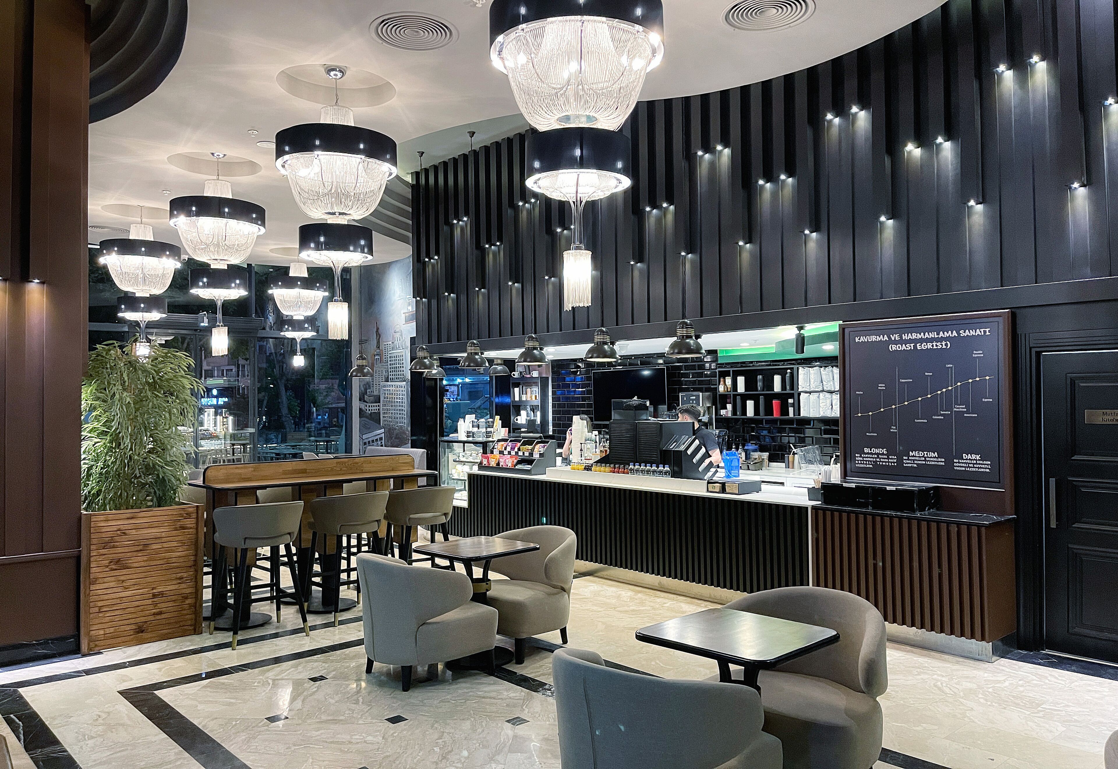 A modern bar area with multiple seating options, a counter with a menu display, and ambient lighting fixtures.