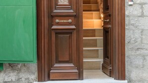 A wooden front door with a small set of stone steps leading to a staircase. - Guarda Il Porto Apartment - Hydra port (Idra)