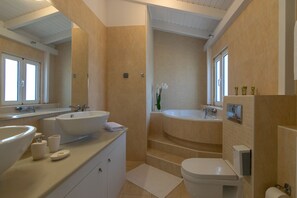 Bathtub, hair dryer, towels, shampoo