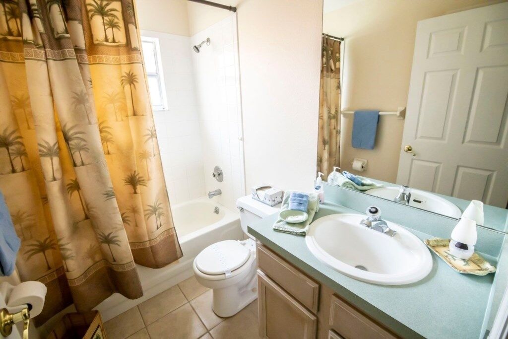 A bathroom with a bathtub, toilet, and sink.