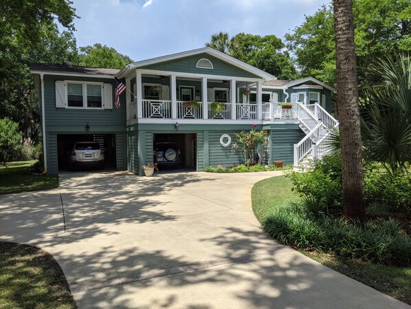 A two-story house with a covered front porch, a garage, and a staircase leading to the upper level.