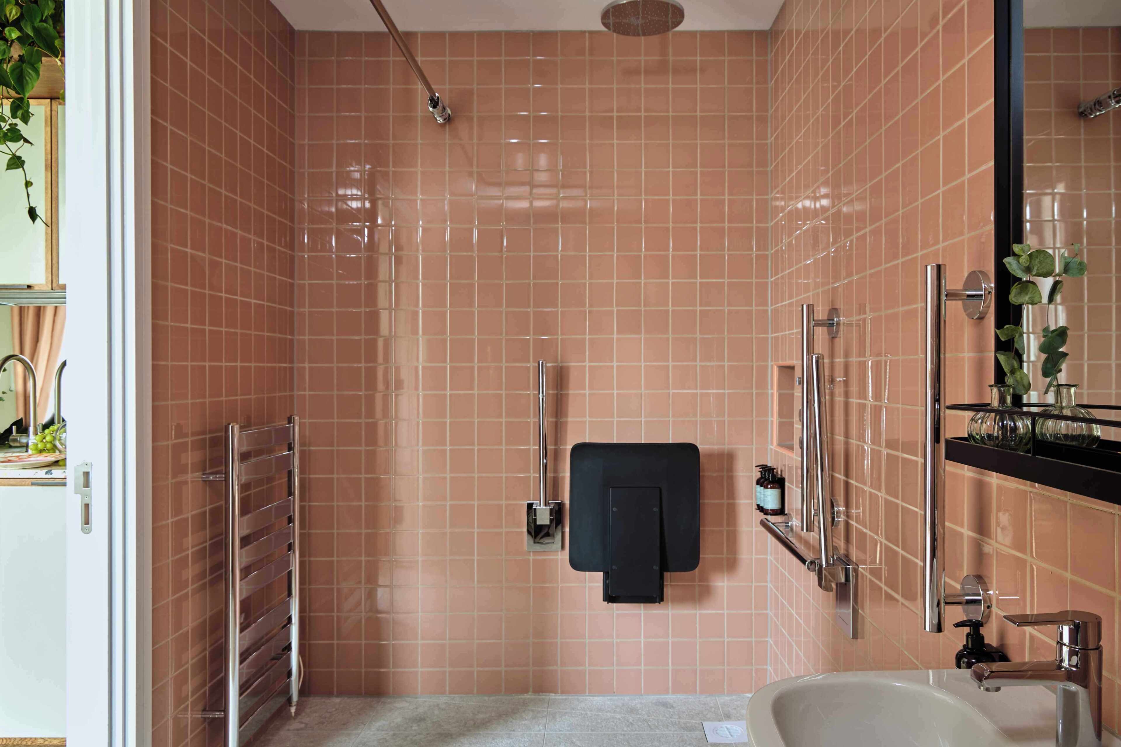 A bathroom with a shower, a sink, and a mirror.