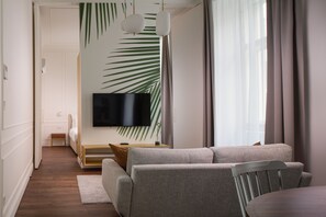 Deluxe Apartment | Living area | 60-cm flat-screen TV with cable channels, TV