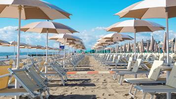 Private beach, white sand, sun loungers, beach volleyball