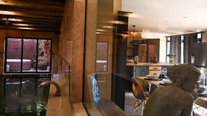 A modern kitchen with a dining area, a large window, and a view of the outdoors.