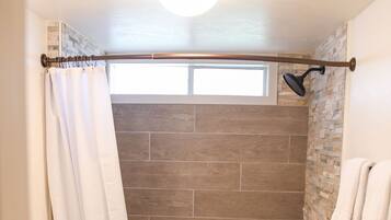 Bathtub, hair dryer, towels, shampoo