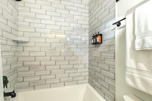 Combined shower/tub, hair dryer, towels, soap