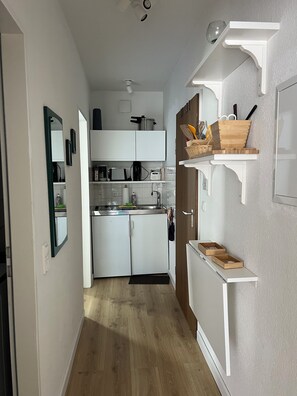 Kühlschrank, Herdplatte, Kochgeschirr/Geschirr/Besteck, Esstisch