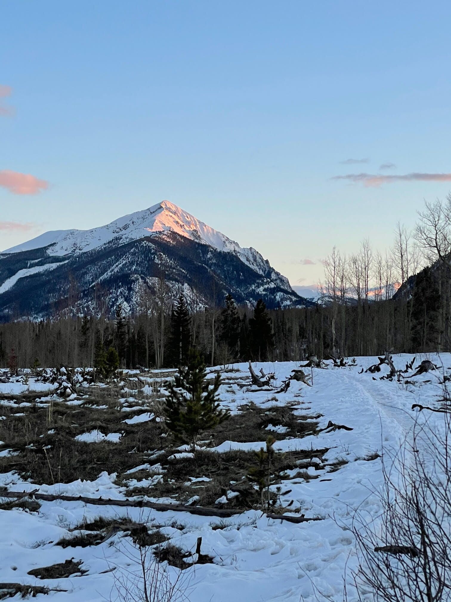 A snowy mountain landscape with a clear sky.