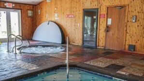 An indoor swimming pool with a wooden wall, a hot tub, and a no-jumping sign. - Mountain-View Condo w/ Pool & Hot Tub Access (Gatlinburg)