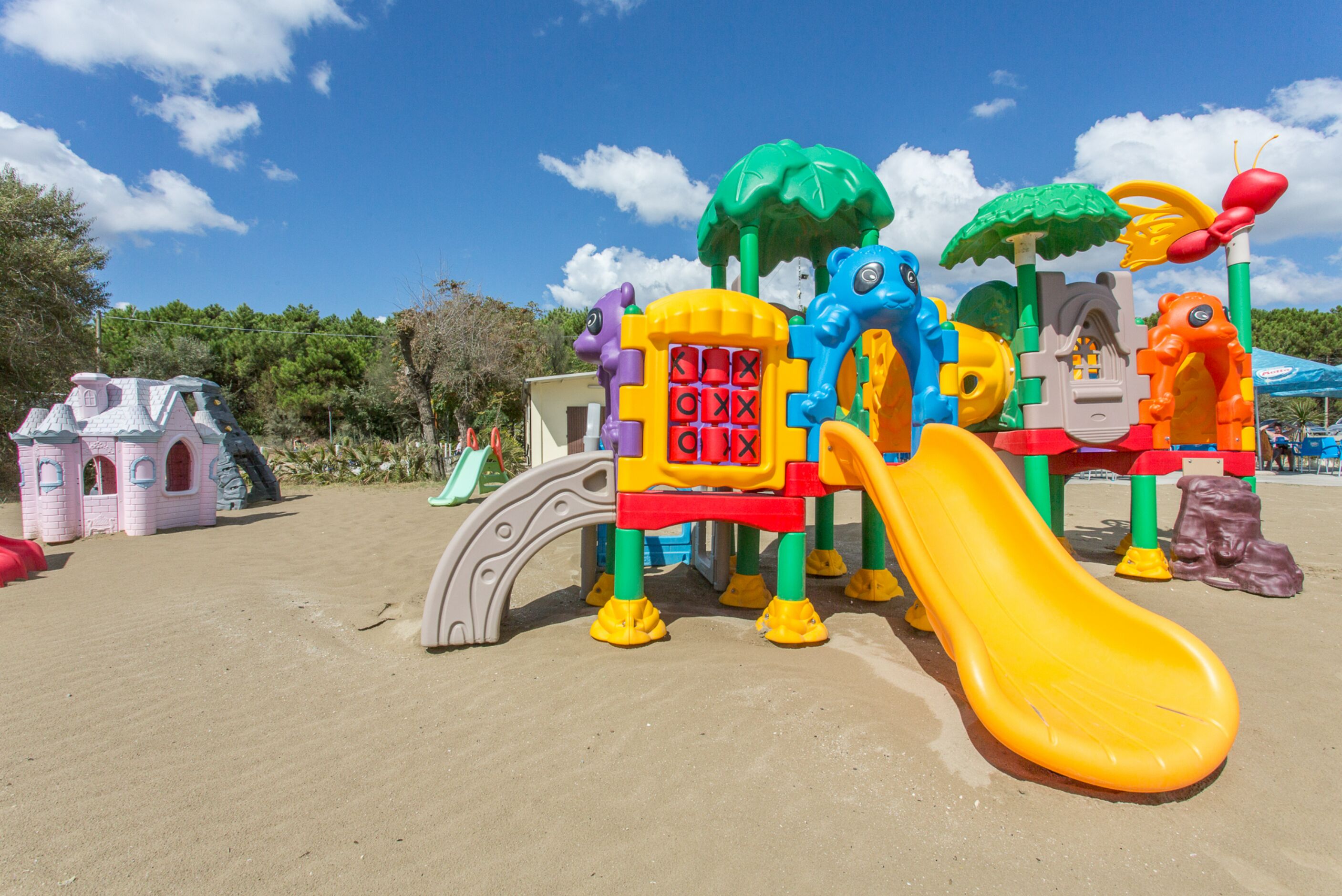 A children's play structure with slides and climbing elements.