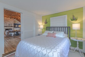 Cozy retreat with a large bed, fireplace, and comfortable seating area.